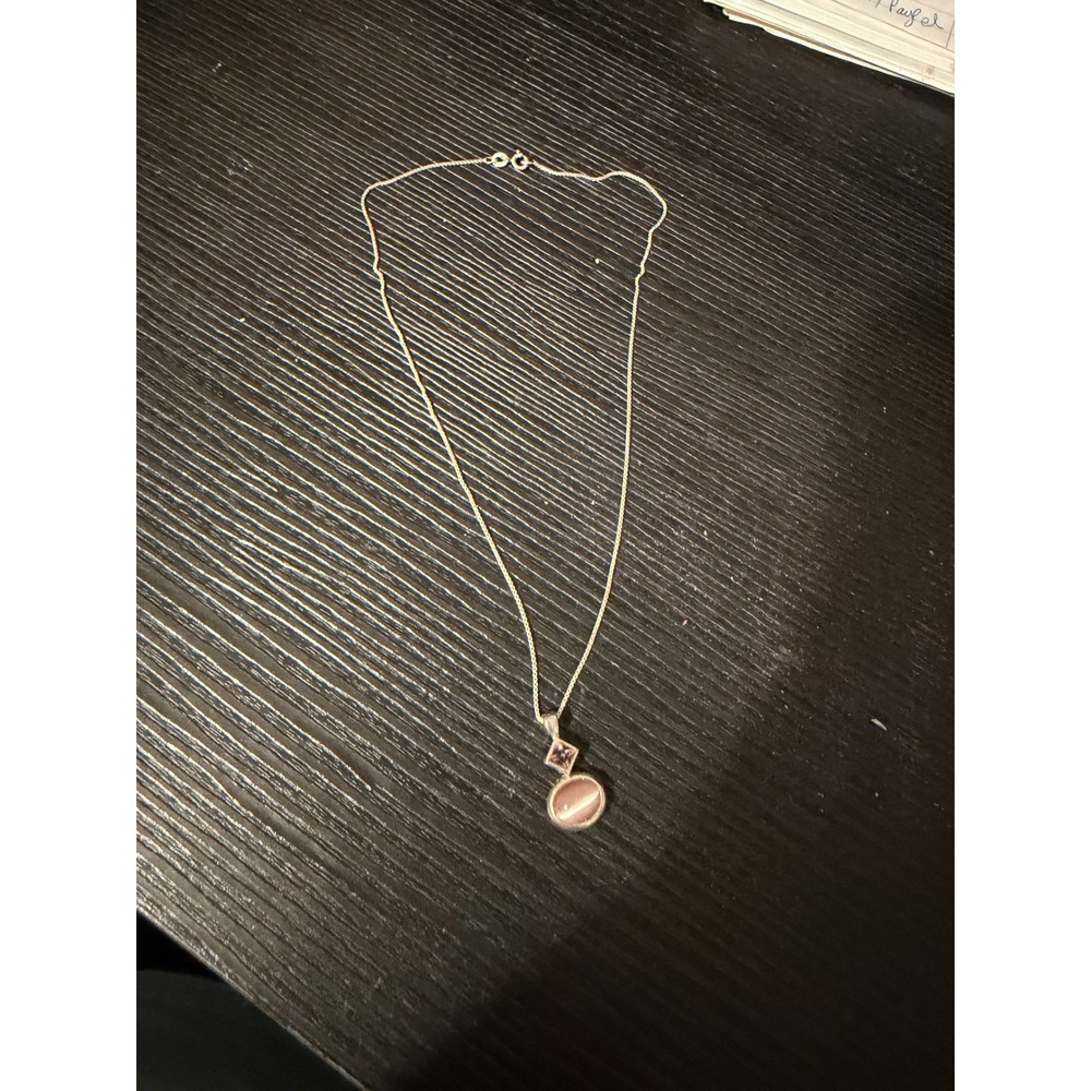 sterling silver chain w/cat's eye stone and an amethyst-colored‎ stone pendant.